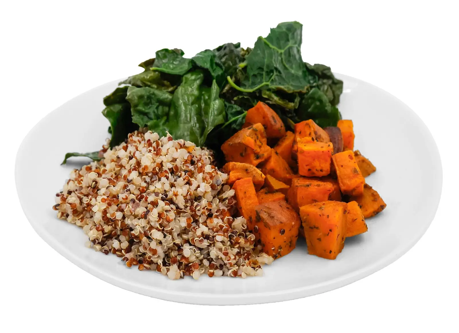 A plate with a bowl of greens, sweet potatoes, and quinoa, creating a healthy and colorful meal.